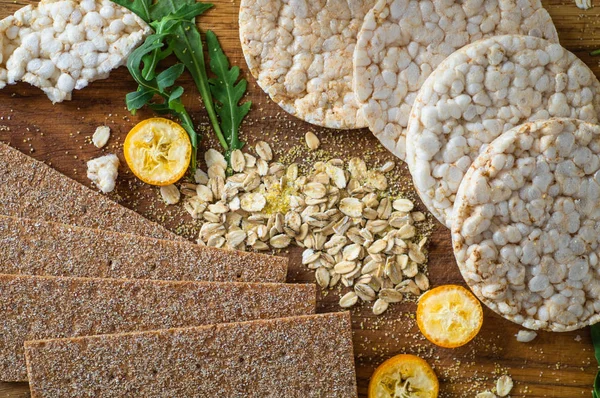 Round crispy rice crackers and Rye Crackers whith kumquat. Dietary concept and healthy vegetarian food.