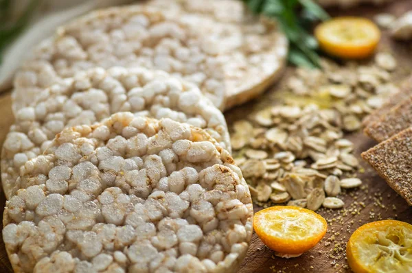 Round crispy rice crackers and Rye Crackers whith kumquat. Dietary concept and healthy vegetarian food.