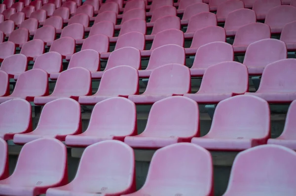Red seats in the stadium. Empty seat of football stadium