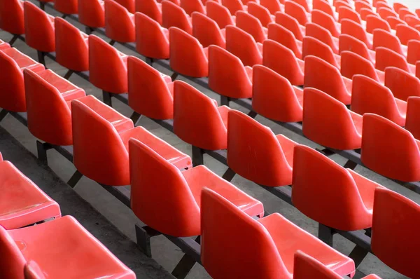 Red seats in the stadium. Empty seat of football stadium