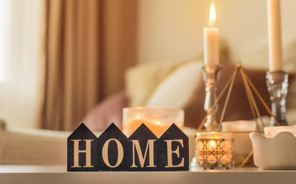 A lot of candles with candlesticks on the home background. Home and home decor. Candles flame — Stock Photo, Image
