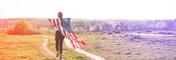 Women running in the field with American flag USA celebrate 4th of July — ストック写真