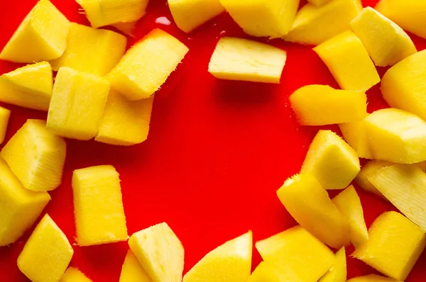 Red cake background with mango. Close up of red cake background.