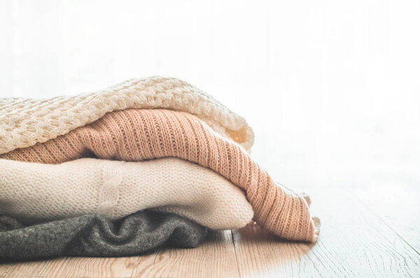 A stack of knitted sweaters in the interior of the living room