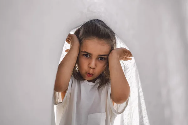 Gelukkig kind. Grappig meisje dat met een deken speelt. Een lachend meisje. Vrolijk kind buiten in de natuur — Stockfoto