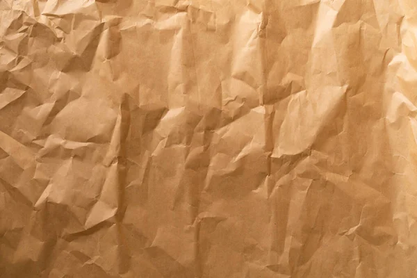 Kraft paper. Wrinkled craft paper. Craft cardboard texture background. Brown texture.