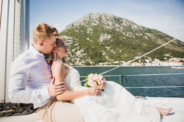 Wedding couple on the luxury yacht sailing down the sea, Montenegro