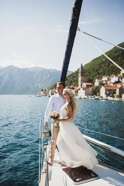 Wedding couple on the luxury yacht sailing down the sea, Montenegro