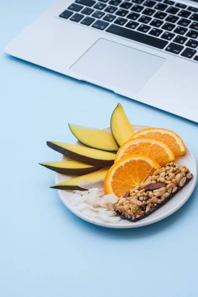 Workspace Laptop Healthy Breakfast Mango Orange Muesli Bar Blue Table — Stock Photo, Image