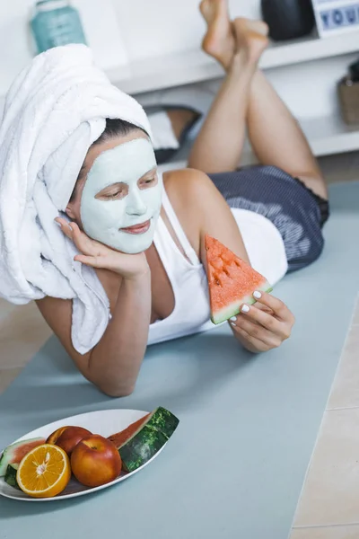 Young Pretty Blonde Woman Towel Head Facial Mask Cucumber Eating — Stock Photo, Image