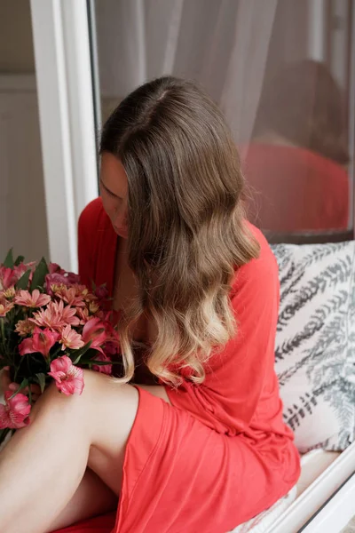 Young Blonde Woman Red Robe Flowers Wide Window Background Having — Stock Photo, Image