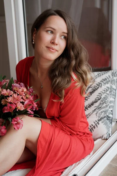 Young Blonde Woman Red Robe Flowers Wide Window Background Having — Stock Photo, Image