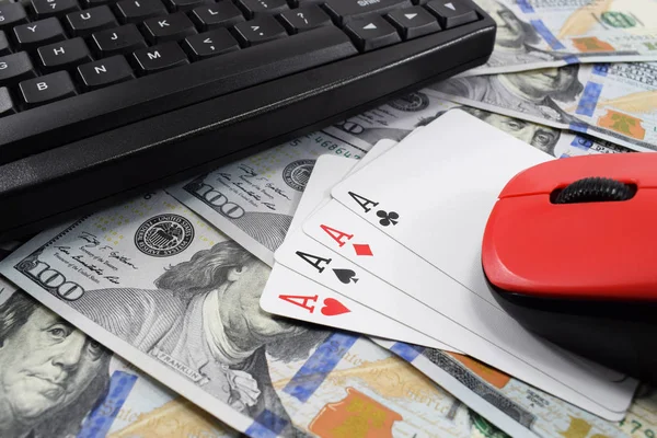 casino online, real money. on the table money (dollars), playing cards, keyboard and mouse from the computer
