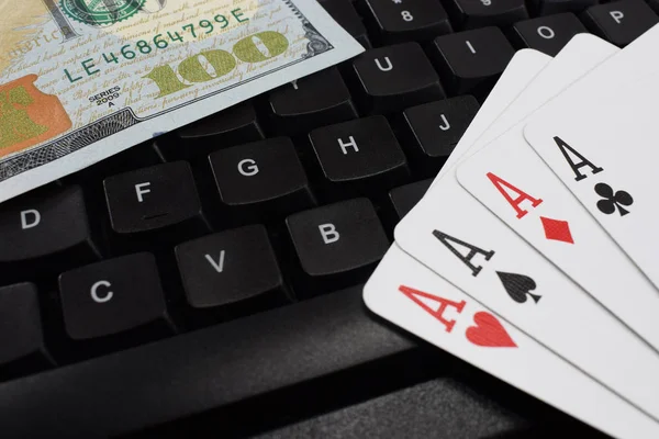 casino online, real money. on the table money (dollars), playing cards, keyboard