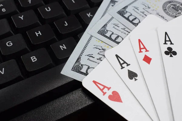 casino online, real money. on the table money (dollars), playing cards, keyboard