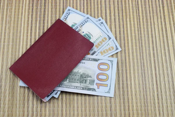 Passport with money (dollars) for vacation lies on the table