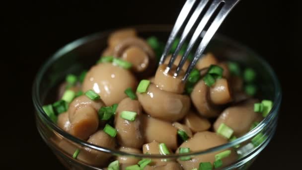 Marinated mushrooms are pinned on the fork — Stock Video