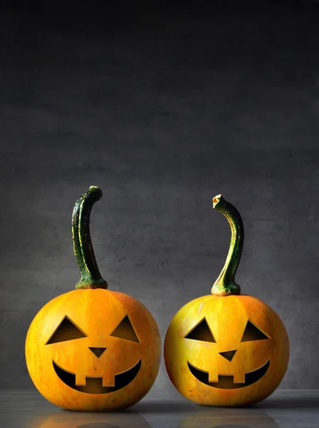 Scary Halloween pumpkins isolated on a black background. Scary smiling faces trick or treat.