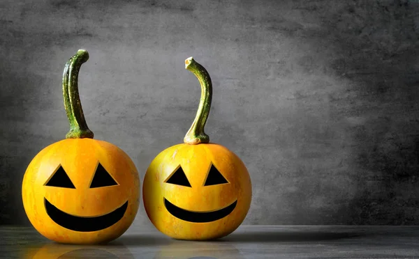 Scary Halloween pumpkins isolated on a black background. Scary smiling faces trick or treat.