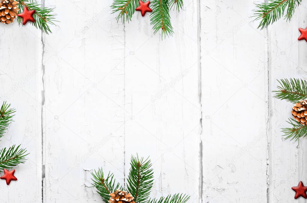 Christmas background with fir branches, pinecones on the old wooden board in vintage style.