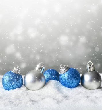 Kar arka planda renkli parlak Noel topları