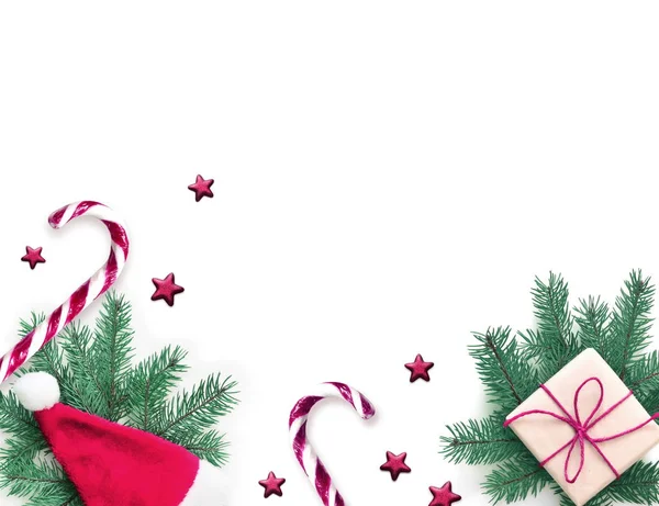 Świąteczna kompozycja. Prezent, jodła, świąteczny kapelusz i słodki kule na białym tle. Boże Narodzenie, zima, koncepcja nowego roku. Płaski lay, widok z góry. — Zdjęcie stockowe
