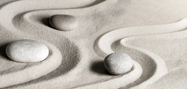 zen garden meditation stone background with stones and lines in sand for relaxation balance and harmony spirituality or spa wellness.