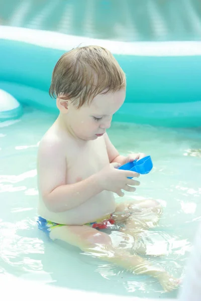 Glücklich schöne kleine Junge badet in Pool — Stockfoto