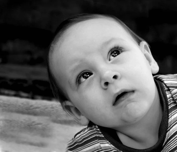 The boy looks with fear up look.black and white photo. — Stock Photo, Image