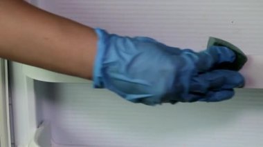 Mavi kauçuk eldiven içinde el yavaş yavaş buzdolabı kapı yakın çekim yıkar
