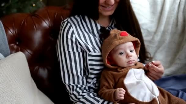 Young Mother Holding Baby Hand Sitting Christmas Tree — Stock Video