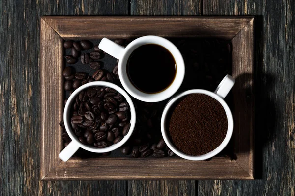 Three types of coffee - ground, grain and beverage, top view, horizontal