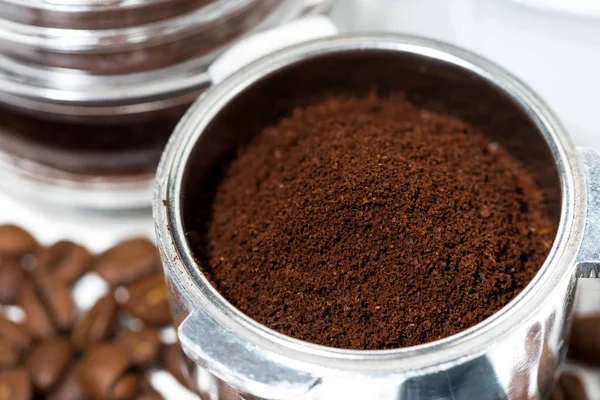 holder with aroma ground coffee on table, closeup horizontal