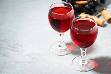 İki bardak kırmızı şarap gri bir arka planda, üst yatay görüntüleme