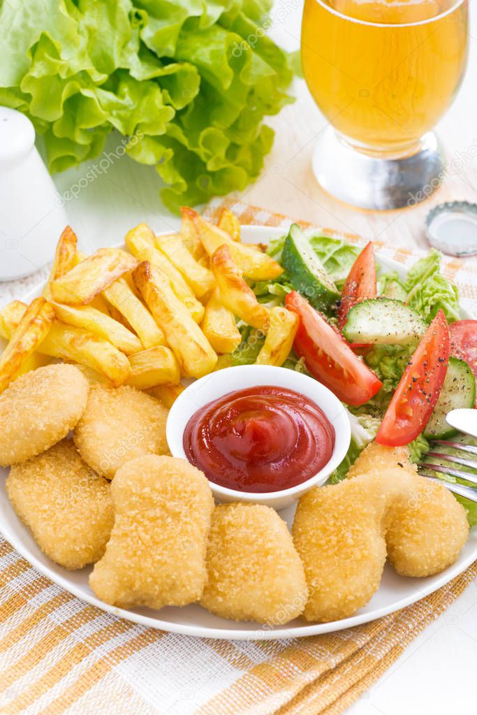 fast food - chicken nuggets, french fries and vegetable salad, v