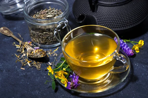 Tea with aromatic herbs on a dark background — Stock Photo, Image