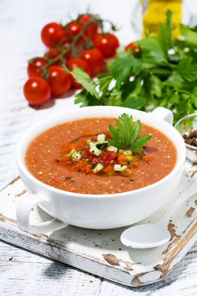 Cold tomato soup in a bowl on white background, vertical — Stock Photo, Image