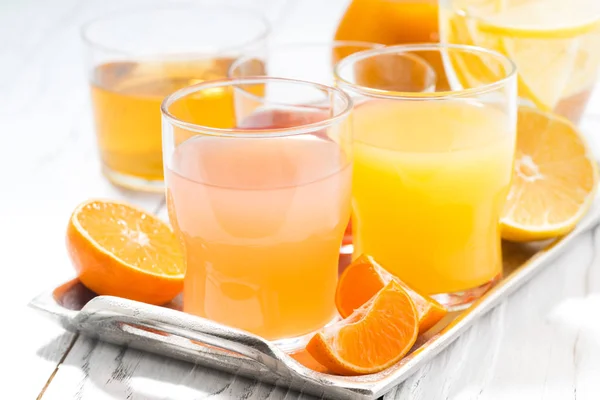 Fresh citrus juices in assortment, closeup — Stock Photo, Image