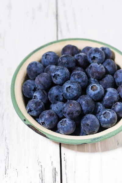 Färska saftiga blåbär i en skål, vertikal — Stockfoto