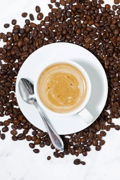 Чашка эспрессо на кофейных зеренах, концептуальная фотография, вертикальная t — стоковое фото