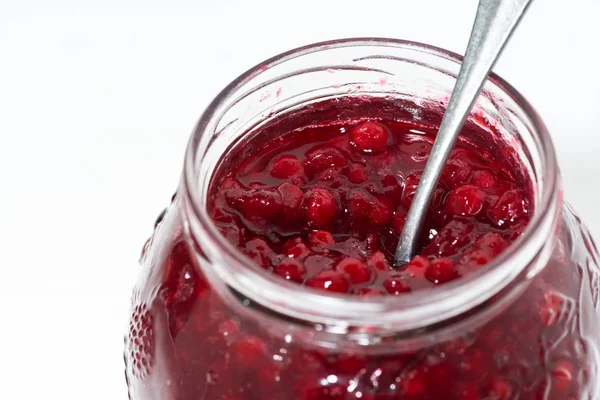 Jar with cowberry jam on white background, closeup — Stock Photo, Image