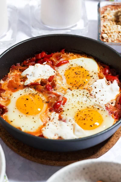 Shakshuka fried eggs in a pan, vertical — Stock Photo, Image