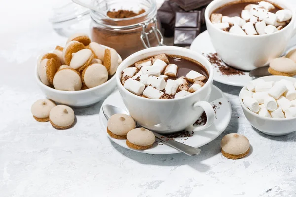 Tazas de chocolate caliente con malvaviscos en la mesa blanca — Foto de Stock