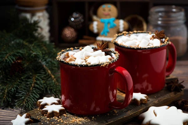 cozy winter drink hot chocolate in red mugs, closeup