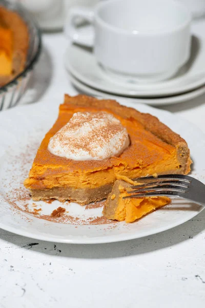 piece of sweet pumpkin pie with cream, vertical top view