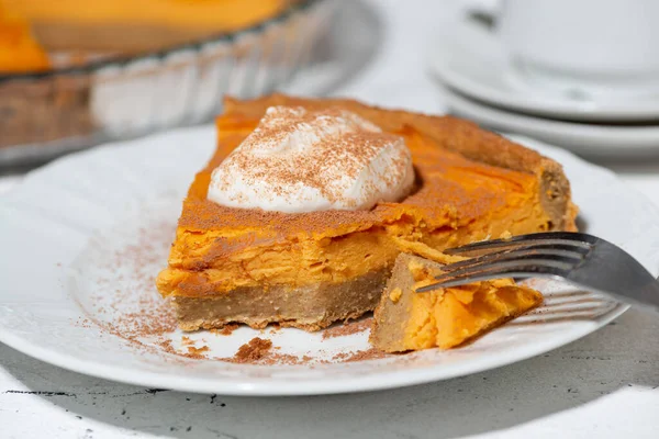 piece of sweet pumpkin pie with cream, closeup