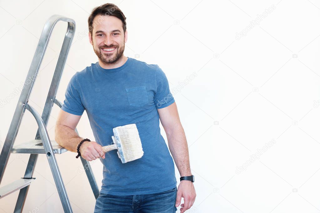 Man portrait with painting tool ready for home renovation.Copy space for text