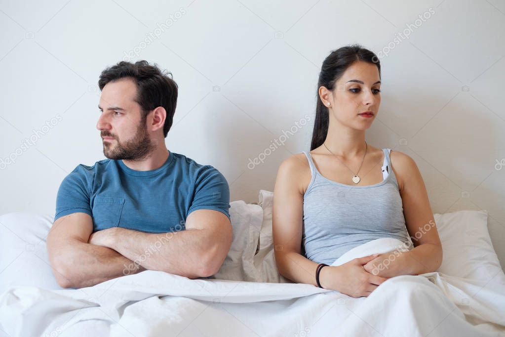 Couple having problem and arguing lying in bed