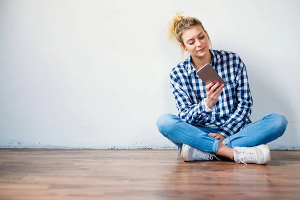 Mädchen Sitzt Auf Dem Boden Und Benutzt Smartphone — Stockfoto