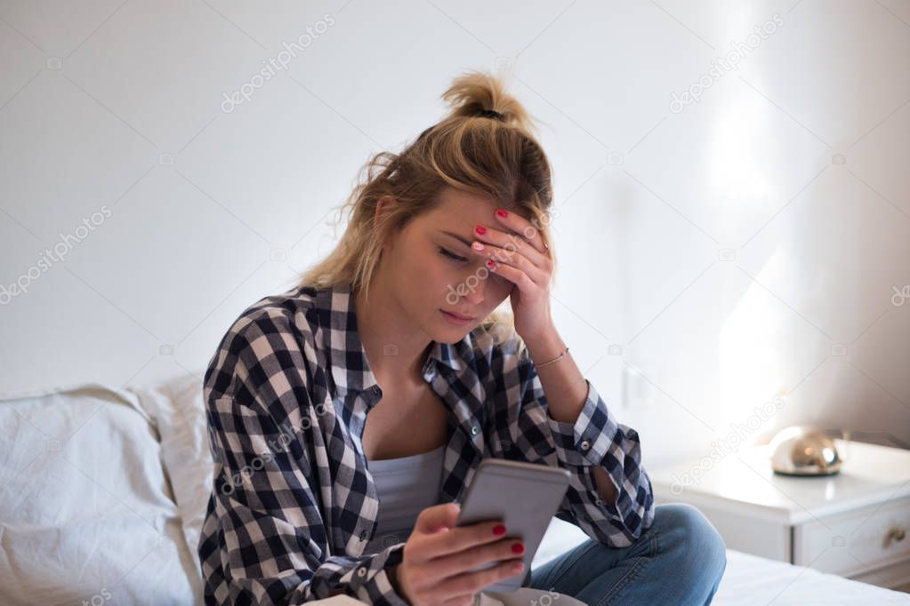 Young woman reading bed news in the bed